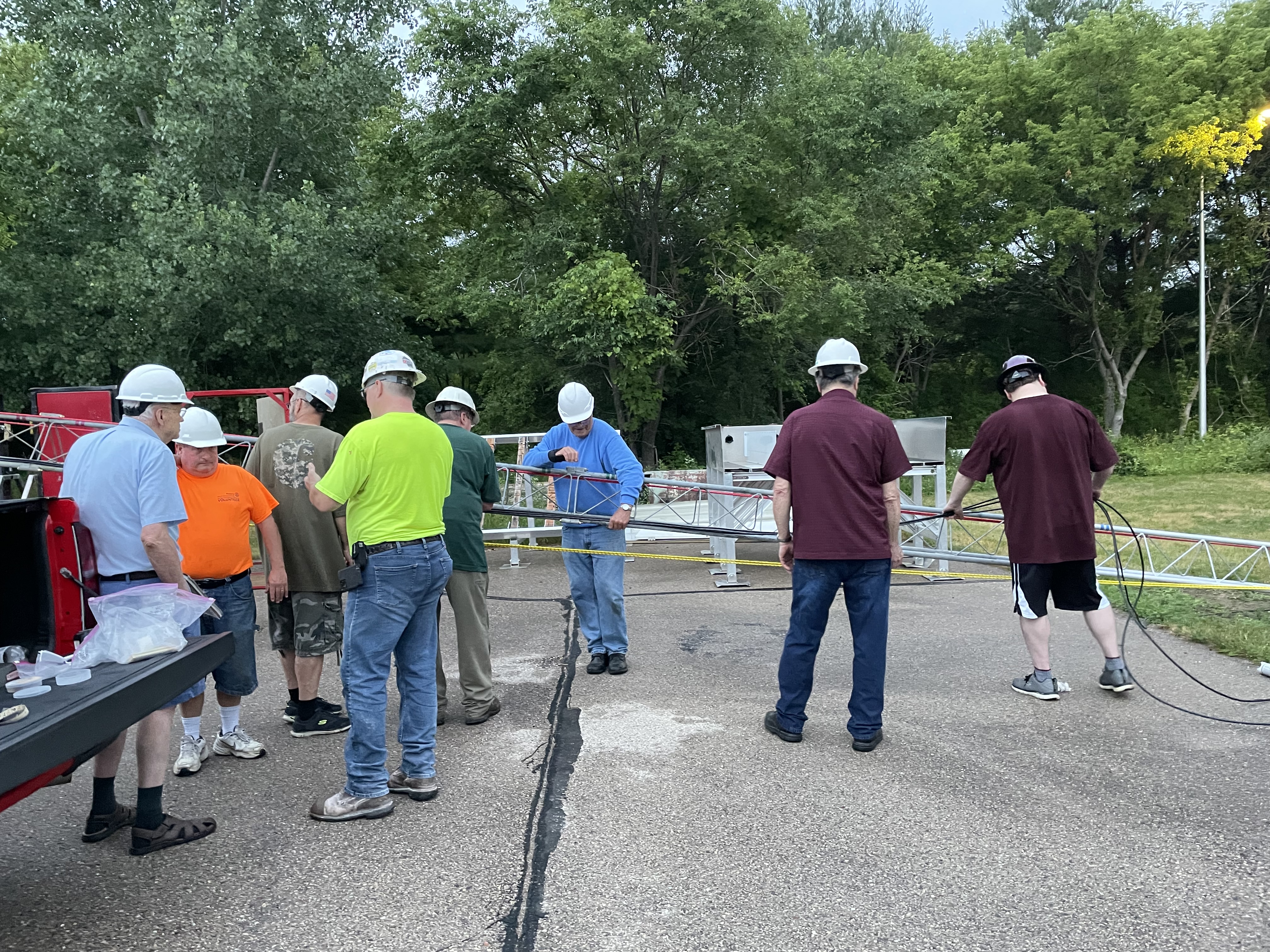 Several club members helping setup a temporary tower for field day.